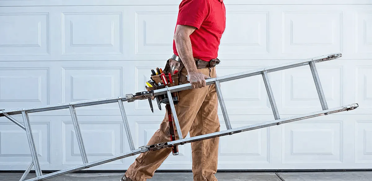 Garage door repair technician arriving with tools and ladder in Syracuse, NY
