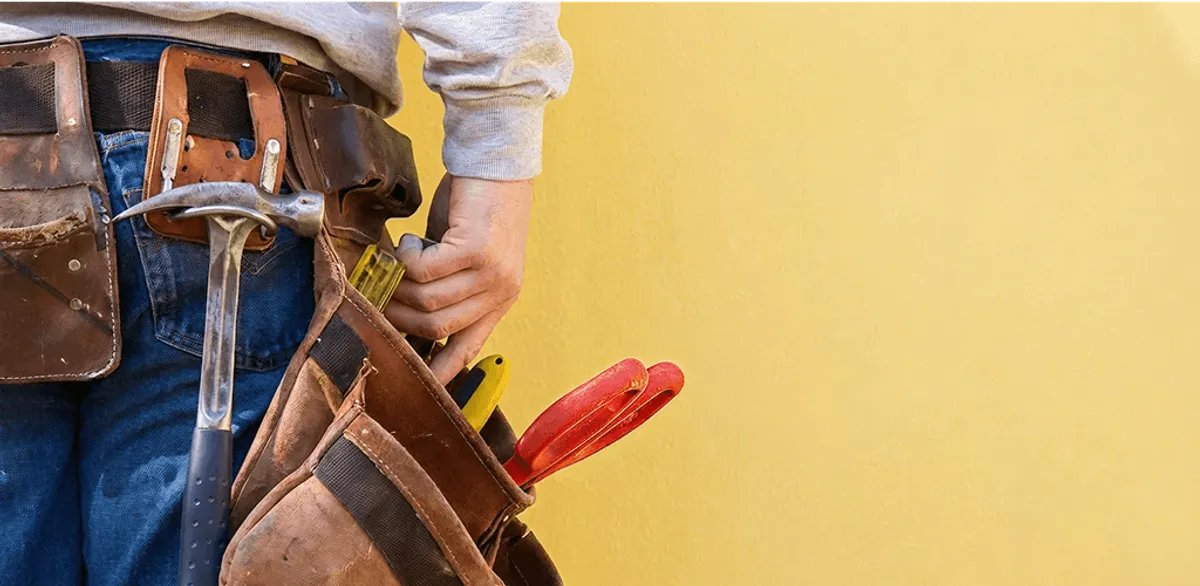 Handyman with tool belt ready for home repairs and maintenance in Syracuse, NY